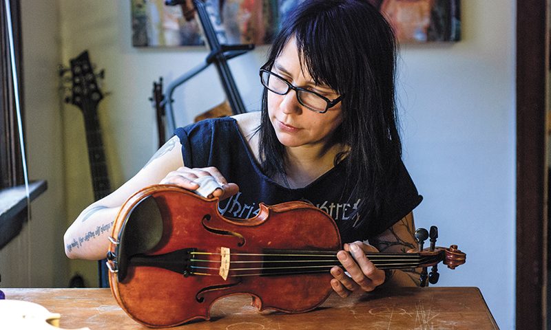 Melissa Collins practices professional violin, viola and cello in luthiere in her home workshop. Photo: rachelmolenda.com