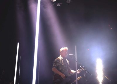 Lead singer Josh Homme stands stage right with a beam of spotlight over him as he provides vocals. Photo: Lmsorenson.net