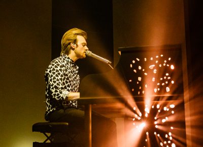 The white piano lights up and FINNEAS plays to a sold-out crowd in SLC.
