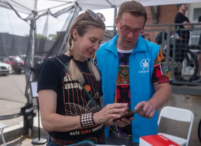 (L-R) Angela Brown, SLUG Cat Race Director, and Rich from Lotus Health sync some details before the 12th Annual SLUG Magazine Alley Cat Race. Photo: John Barkiple.