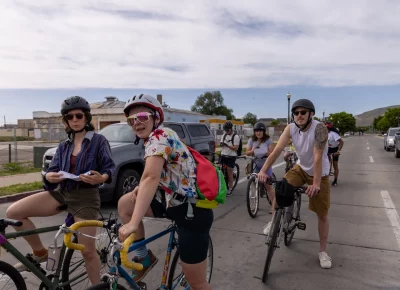 (L-R) Megan, Molly and Kent wait at a light as they head to Level Nine Sports en route to adventure in Salt Lake’s underground cycling scene. Photo: TaCara DeTevis.
