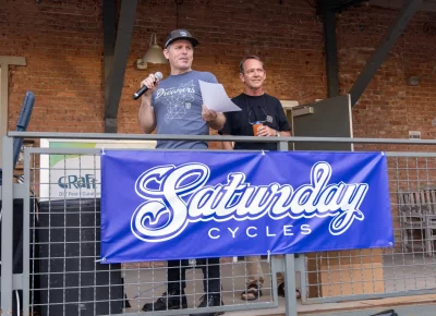 (L-R) SLUG Magazine’s John Ford announces the winners of the 12th Annual SLUG Cat with Mark from Saturday Cycles as his side. Photo: John Barkiple.
