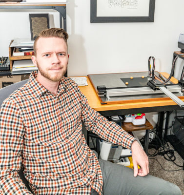 Andew Jensen poses in work space.