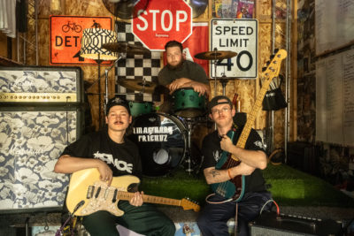 Three band members holding their instruments.