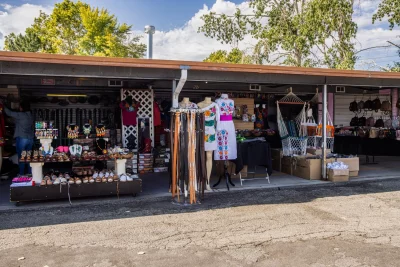 A permanent vendor booth displaying handmade dresses and shoes. 