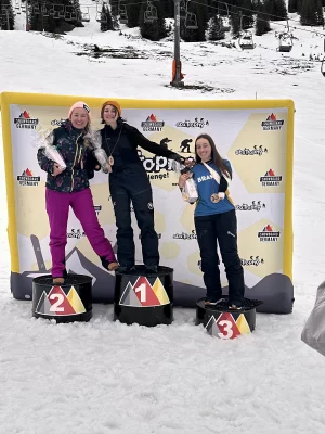 Izy Hicks stands on the first place pedestal with other award winners. 