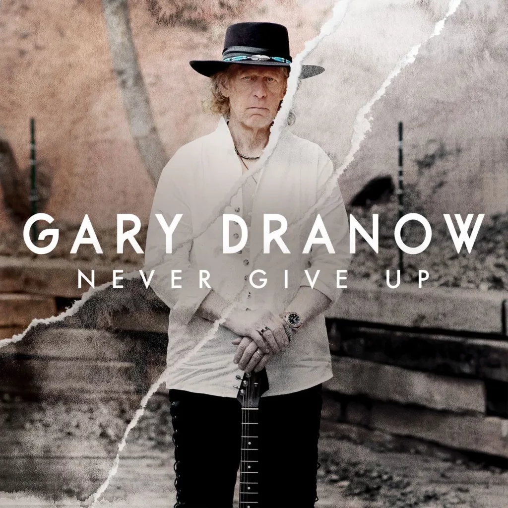 Album cover with a man standing holding a guitar.