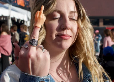 A fan wears a tiny hand with its middle finger up.