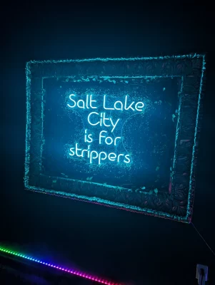 A blue LED light up sign that reads "Salt Lake City is for strippers."