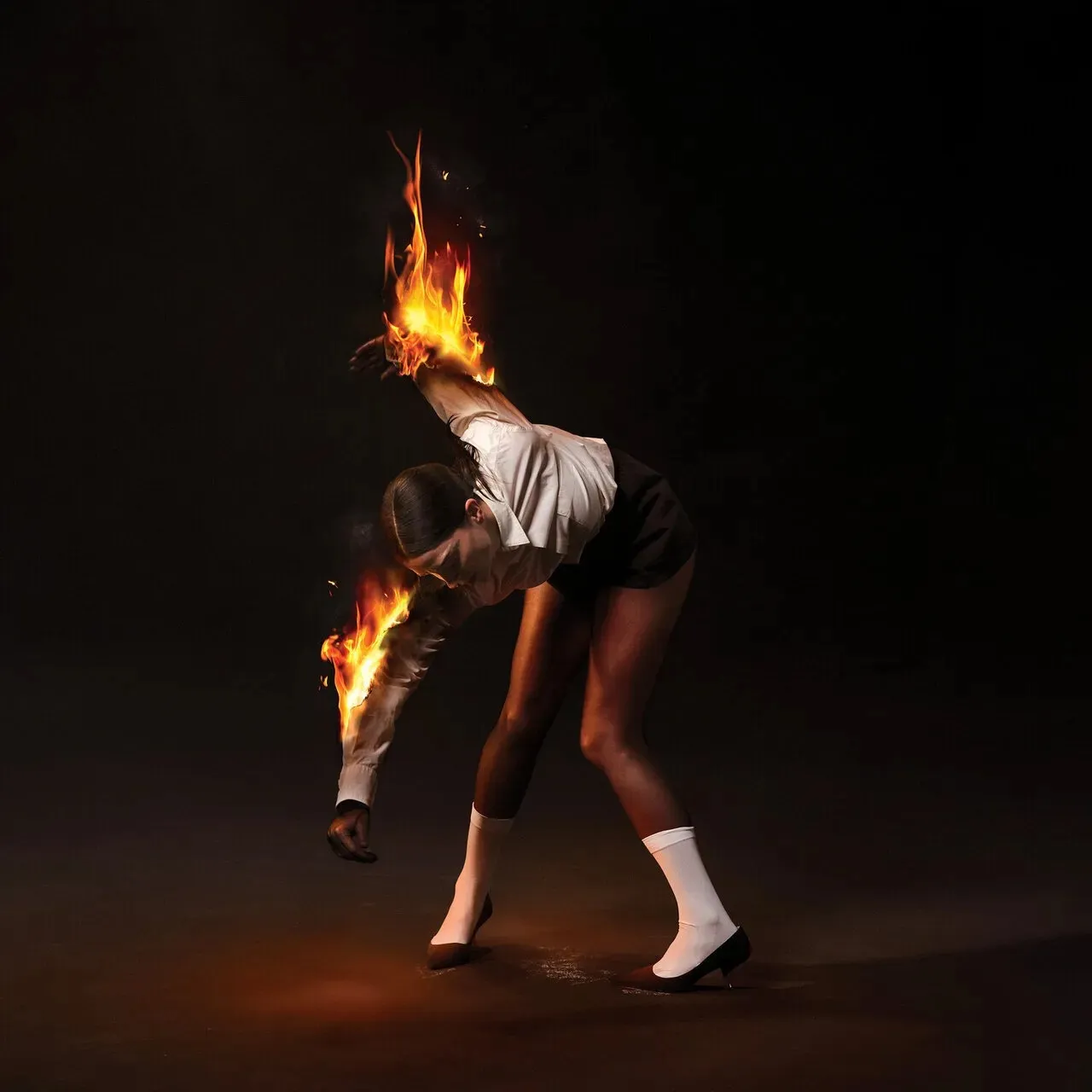 Album cover with a woman on fire.
