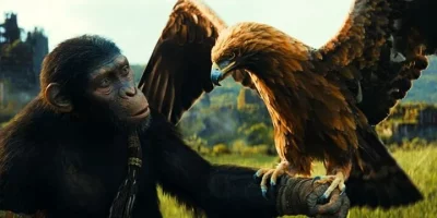 Ape from Planet of the Apes holds an eagle of his arm.