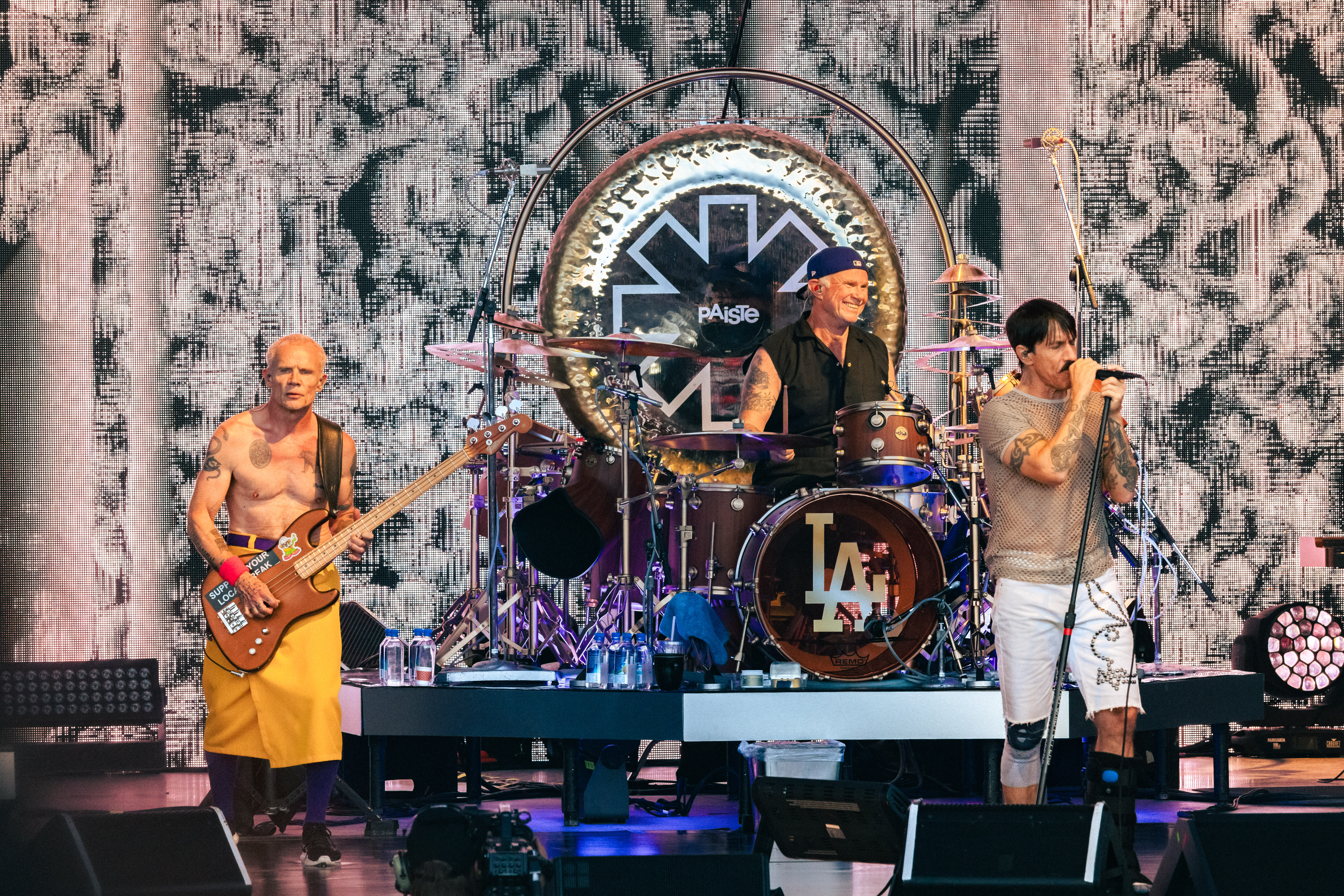 Red Hot Chili Peppers members Flea and Anthony Kiedis play on stage with drummer Chad Smith sporting a big ‘ole smile while on stage at the Utah First Credit Union Amphitheatre. Photo: @lmsorenson