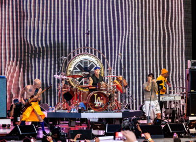 The Red Hot Chili Peppers play on stage in Salt Lake City as tour photographer David Mushegain shoots some images towards the crowd, just behind Flea. Photo: @lmsorenson