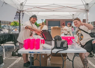The SLUG crew preps the drink stations for a thirsty crowd at the 2024 Brewstillery. Photo: Talyn Behzad.
