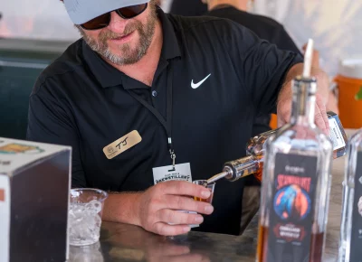 TJ from Clear City Distillery pouring whiskey to mix into a Whiskey Sour. Photo: Chay Mosqueda.
