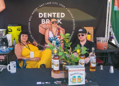 (Left to right) Danielle, Jes, and Connor rocked the booth for Dented Brick, a local distillery in South Salt Lake. Photo: Chay Mosqueda.