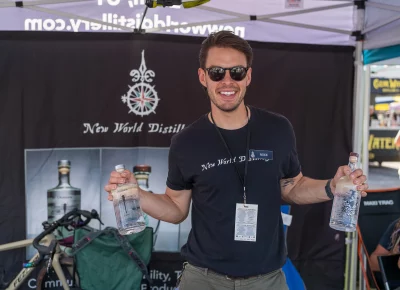 Mike from New World Distilling shows of two of their products, Gin and Tequila both made here in Utah with agave straight from Jalisco. Photo: Chay Mosqueda.