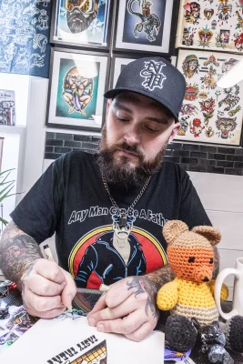 Tattoo artist Cory Harris designing his next tattoo.