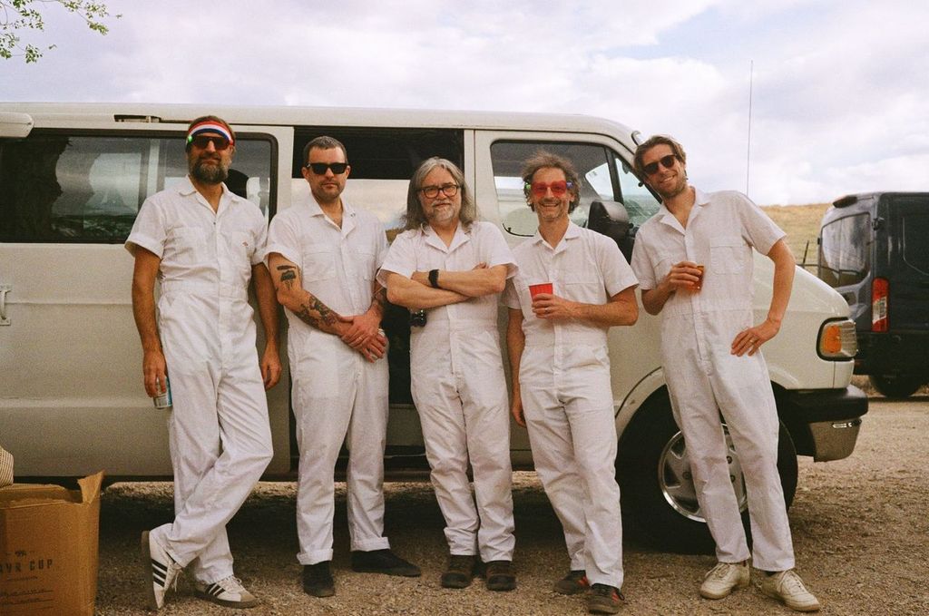 MØTRIK (L–R: Erik Golts, Jonah Nolde, Dave Fulton, Cord Amato, Lee Ritter) stands in front of their van before going onstage at Schellraiser Festival in McGill, Nevada. Photo: Harper Haase