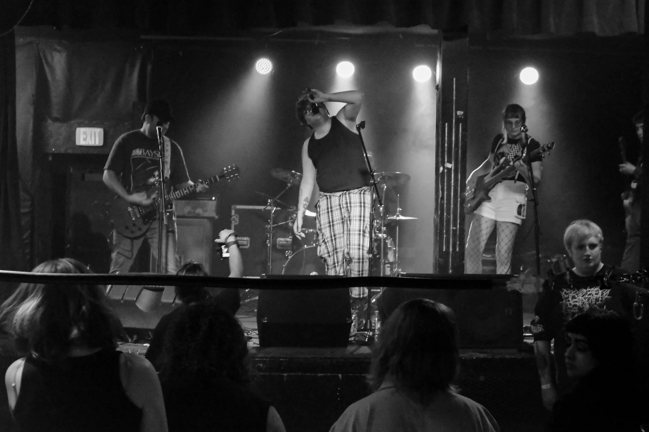 A black and white photo of Still Fighting God performing at the Beehive.