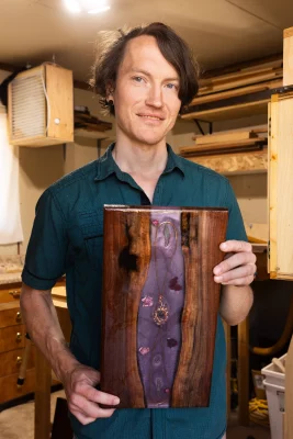 Michael Luna holds up one of his woodworking creations. 