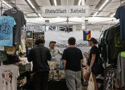 Folks gather together at the Steadfast: Rebels booth. Photo: Diego Andino.