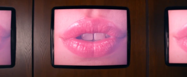 Three TV screens displaying a woman's mouth.