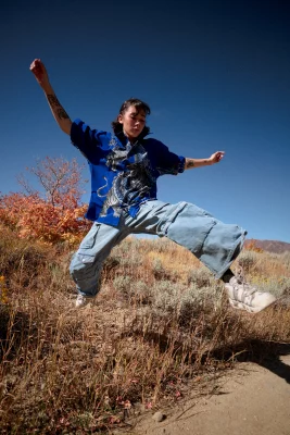 Chloe Akira jumps from the grass to the trail