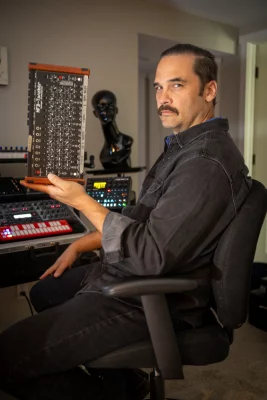 Chris Nielsen holds a sound board. 