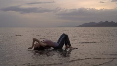 A person laying on their back in the Great Salt Lake. 