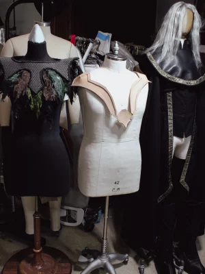 Three of McGrew's fantasy costumes on display on mannequins. 