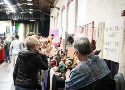 Attendees are intrigued by The Sin Eater's Lament's incredible dolls. Photo: Dominic Jordon.