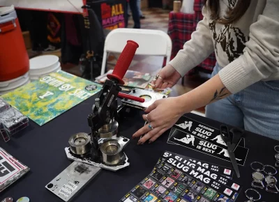 Make your own buttons at the SLUG booth. Photo: Evan Hancock.