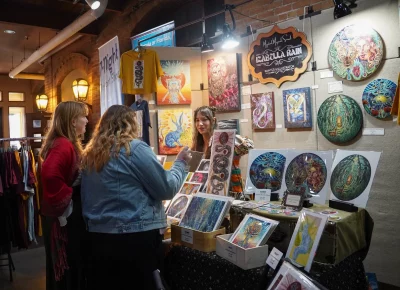 Customers are in awe of the intricate paintings on display. Photo: Evan Hancock.