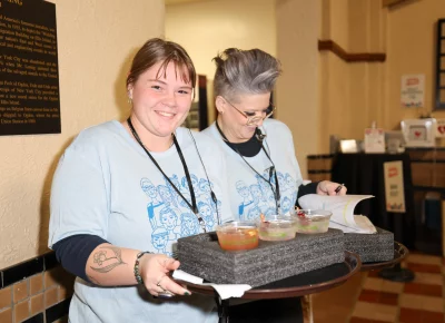 Volunteers gladly serve up tasty drinks. Photo: John Barkiple.