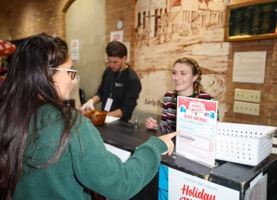 The Holiday Market bartenders are all about service with a smile. Photo: John Barkiple.