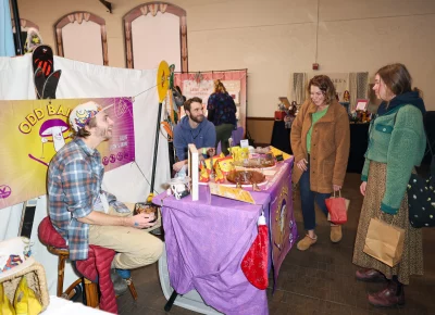 Attendees are intrigued by Odd Balls' mushroom treats. Photo: John Barkiple.